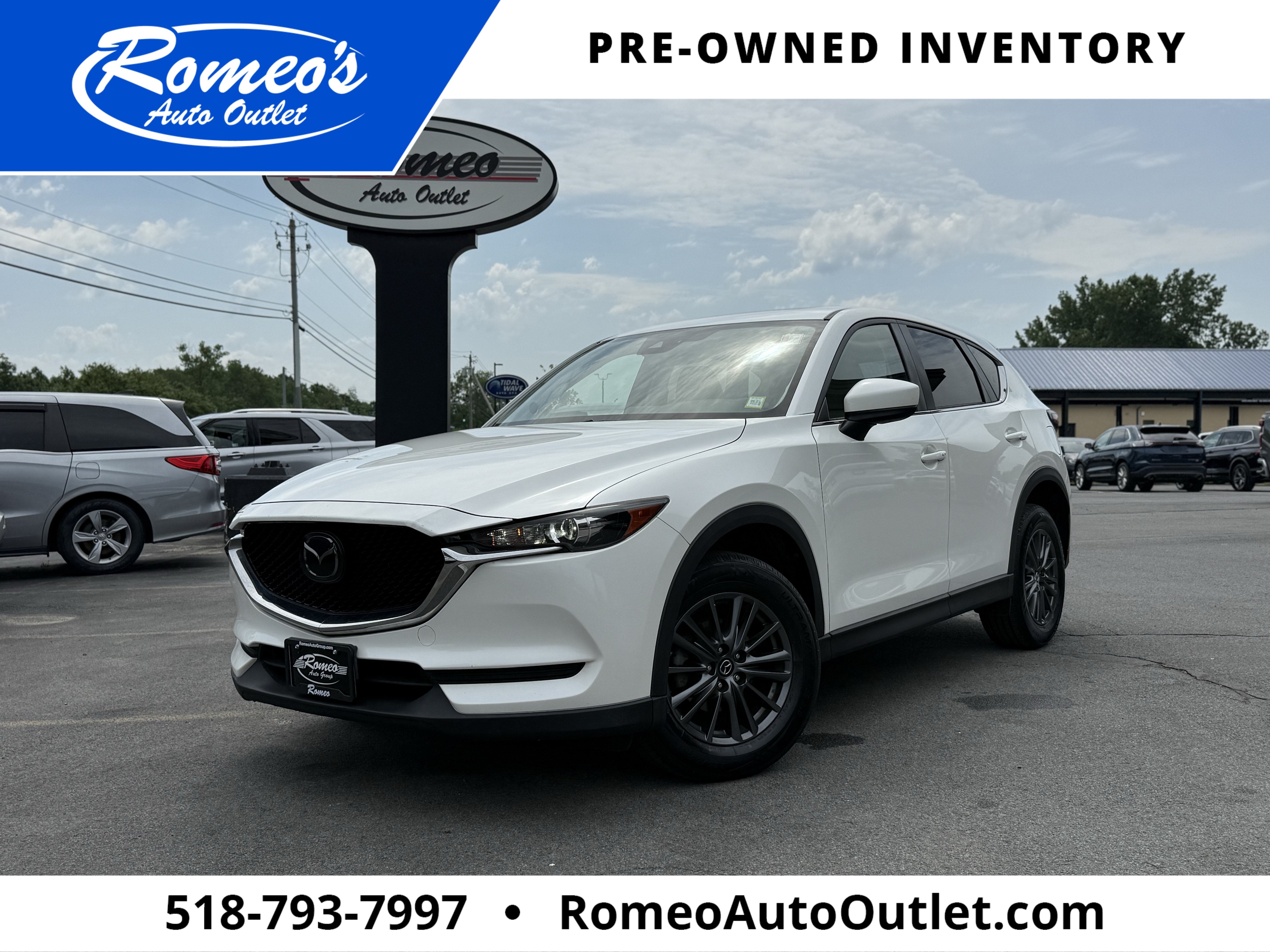 2019 Mazda Mazda CX-5 Touring in Snowflake White Pearl Mica — front three-quarter view